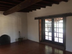 Plastered mud Adobe with Native wood beams